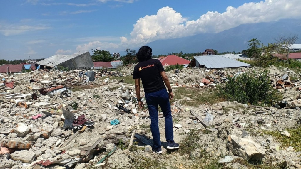 Direct Relief Intern Aprisal Malae surveys ruins in his native Central Sulawesi. (Aprisal Malale for Direct Relief)